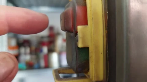 Close-up of a finger pressing the red stop button and green start button on indu 库存影片 336486519