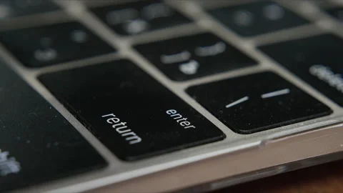 Close up of finger pressing return key on laptop keyboard Stock Footage 340401023