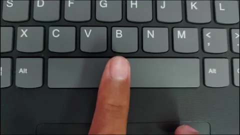 Close up of a finger pressing the spacebar button on a black laptop keyboard. 스톡 동영상 348376565