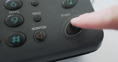 Close-up, finger pressing the start button on an old fax, analog transmission of Stock Footage 289301182