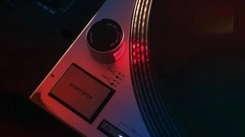 Close up of finger pressing start button on vintage turntable with rotating.. Stock Footage 339117313