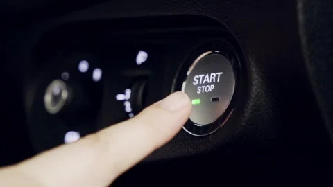 Close-up of a finger pressing the start-stop button to turn off an electric car Stock Footage 314770756