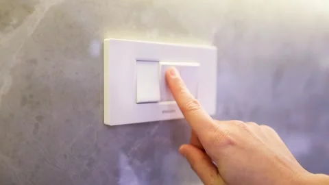 Close Up of Finger Pressing White Light Switch on Marble Wall Stock Footage 332098784