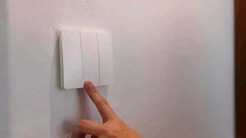 Close Up of a Finger Pressing a White Light Switch Button 動画素材 332828138