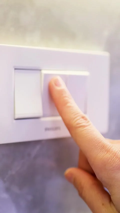 Close Up of Finger Pressing White Light Switch on Marble Wall Stock Footage 333294190