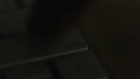 Close-up, finger quickly and many times presses the key of the keyboard shift Video stock 150482677