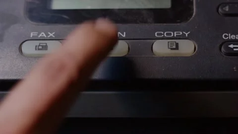 Close-up of a finger repeatedly pressing a scan button on a malfunctioning .. Vídeos de archivo 338225882