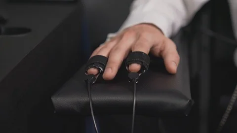 Close up of finger sensor of lie detector on male hand Stock Footage 122627499