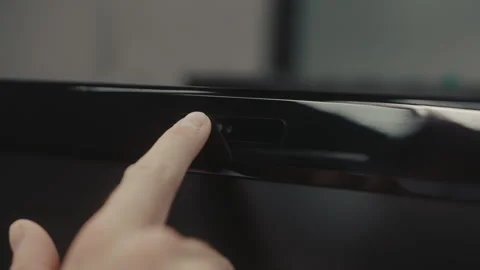 Close-up of finger sliding physical privacy shutter over laptop webcam. Concept Stock-Footage 342930722