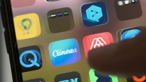 Close-up of a finger tapping app icons on a smartphone home screen. Stock Footage 345025016