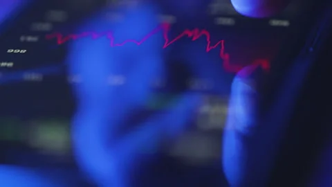 Close-up of finger tapping on smartphone trading app with market data Stock Footage 328276205