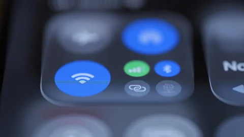 Close up of a finger tapping Wi-Fi and connectivity controls on a iphone screen. Stock Footage 334023247