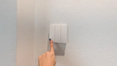 Close Up of a Finger Toggling a White Light Switch Indoors Stock Footage 335808245