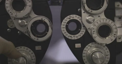 Close up on finger turning knob making phoroptero ophthalmic machine optics  Video stock 239665383