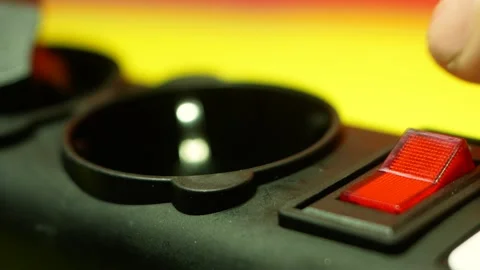 Close-up of a finger turns on the red button of an electrical appliance. Red but Vídeos de archivo 151522553