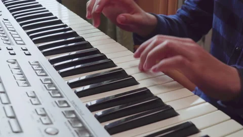 Close-up of fingers of a boy learning playing the piano. Stock-Footage 154772177