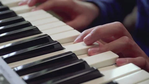 Close-up of fingers of a boy learning playing the piano. Stock Footage 154932928