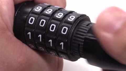 Close-up of fingers closing a combination lock on a white background Stock Footage 134603503