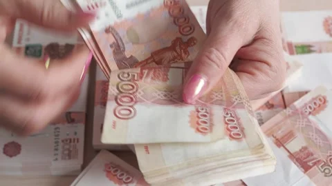A close-up of the fingers of a hand counting five thousandth banknotes of the Stock Footage 267055011