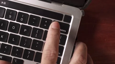 Close-up of fingers pressing the delete key on a computer keyboard Video stock 330552769