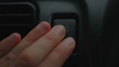 Close-up of fingers pressing rear window defroster... 動画素材 339101306