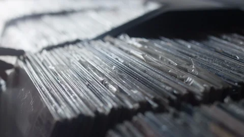 Close-up of fingers sifting through a row of vinyl music records 스톡 동영상 122596730