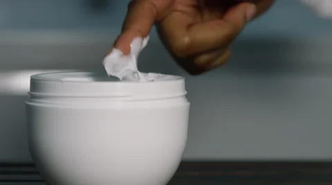 Close up of fingers taking moisturiser from a container, in slow motion Video stock 57225139