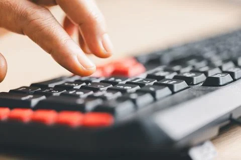 Close-up of fingers typing on computer keyboard for data entry and online w.. Stockfoto's