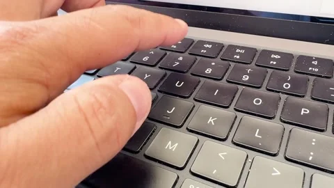 Close-up of fingers typing on dusty laptop keyboard Stock Footage 340899143