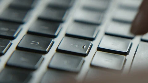 Close up of fingers typing on laptop computer keys Stock Footage