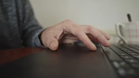 Close up of fingers using laptop trackpad during morning coffee ritual Stock Footage 337767930