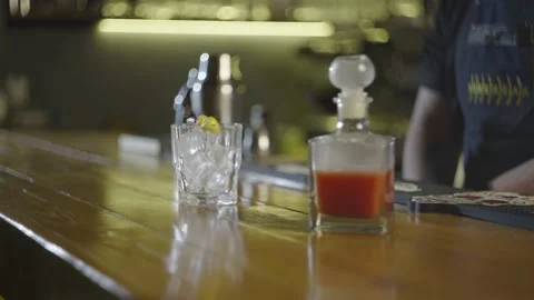 A close-up of the finished cocktail, which is flavored by the bartender at bar Stock Footage 236900636