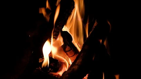Close up fire burning in the fireplace. Video of fire flames over dark backgr Video stock 92239667