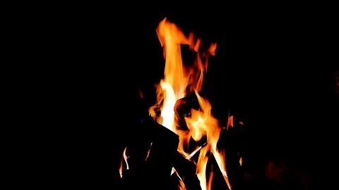Close up fire burning in the fireplace. Video of fire flames over dark backgr Stock Footage 93890416
