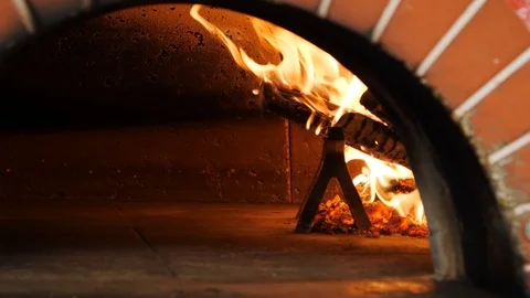 Close up of fire burning inside pizza oven  Stock Footage 86897515