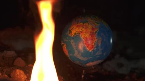 Close up of fire burning near globe on destructed floor with a lot of rocks Stock Footage 152739707