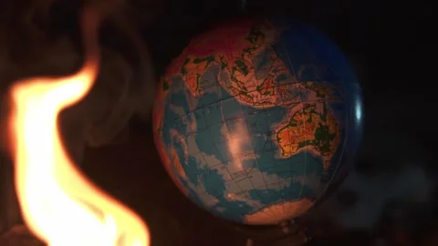 Close up of fire burning near globe on destructed floor with a lot of rocks Stock Footage 152795506