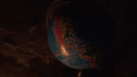 Close up of fire burning near globe on destructed floor with a lot of rocks Stock Footage 152864090
