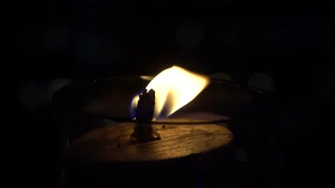 Close-up.The fire burns behind the glass in a gas lamp against. The candle burns Stock Footage 162619482