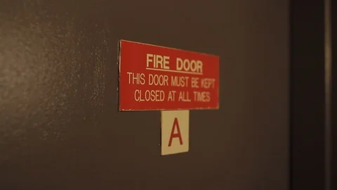 Close up “fire door” sign slow gimba... | Stock Video | Pond5