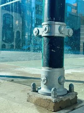 Close-up of a fire hydrant on city sidewalk Stock Photos