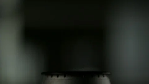 Close-up fire lights up on a gas burner on a chef's stove Stock Footage 113613423