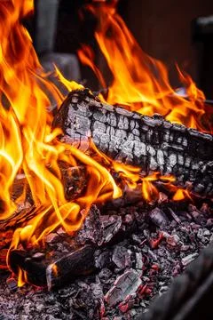 Close up of fire with orange red flames burning in darkness. Coal fire Stock Photos