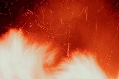 Close-up of a fire with sparks flying in a dynamic pattern Stock Photos