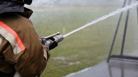 Close-up of firefighter extinguishing fire with fire hose Stock-Footage 123929993