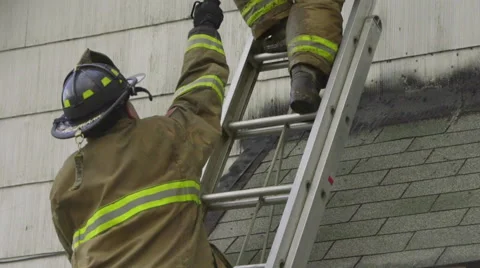 Close up of firefighters on a ladder Stock Footage 60795139