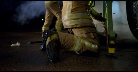 Close Up Of Fireman Walking Towards Car Crash Stock Footage 143540488
