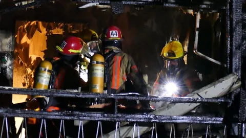 Close-up of firemen chatting at burned building fire Stock Footage 119947341