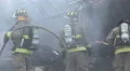 Close Up Firemen With Hose At Smoking Wreckage 02 4k or 4k+ Resolution