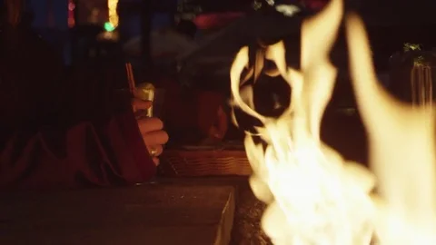 Close Up of Firepit on a Patio with People drinking hot drinks in Background Stock Footage 83359192
